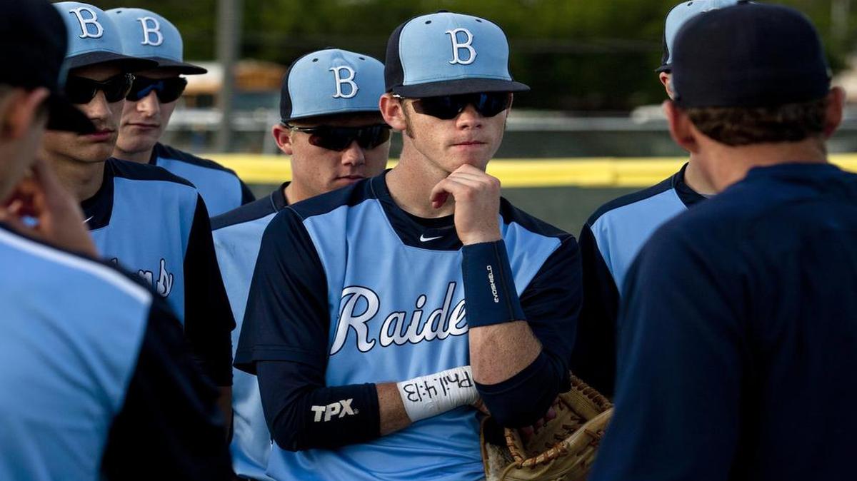 
L.D. Bell senior shortstop Logan Herd, center, listens to his coach during a pep talk on April 29. Herd is still getting to know his teammates, friends and family members after losing his memory.

