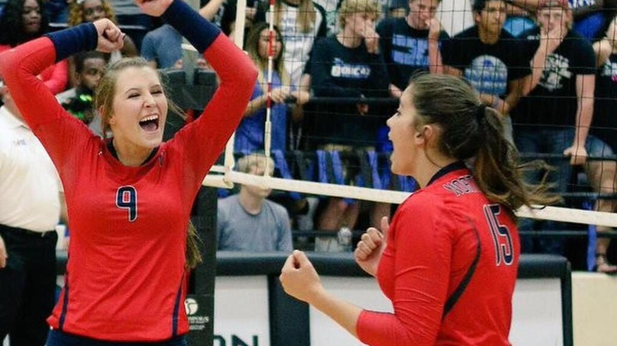 Justin Northwest’s Camryn Berryhill (left) and Bailey Cagle celebrate a point during the 2015 season.