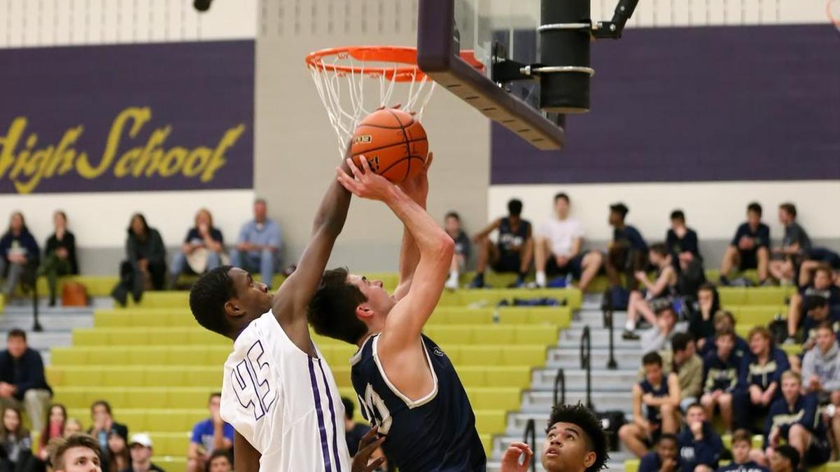 Nabil Rurangirwa, left, blocks a shot against Keller last season.