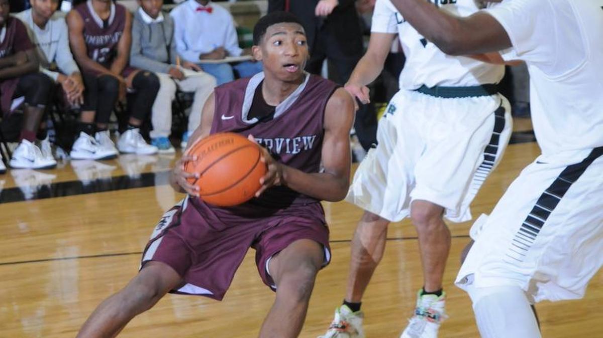 Timberview's Chris Mullins, left, drives to the basket in a game against Lake Ridge in 2014.