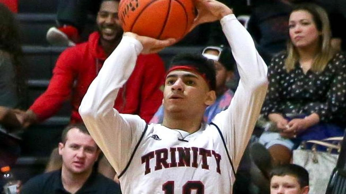 Trinity guard Jhivvan Jackson (10) attempts a 3-point shot against Southlake Carroll during the 3rd quarter Friday night, February 6, 2015.