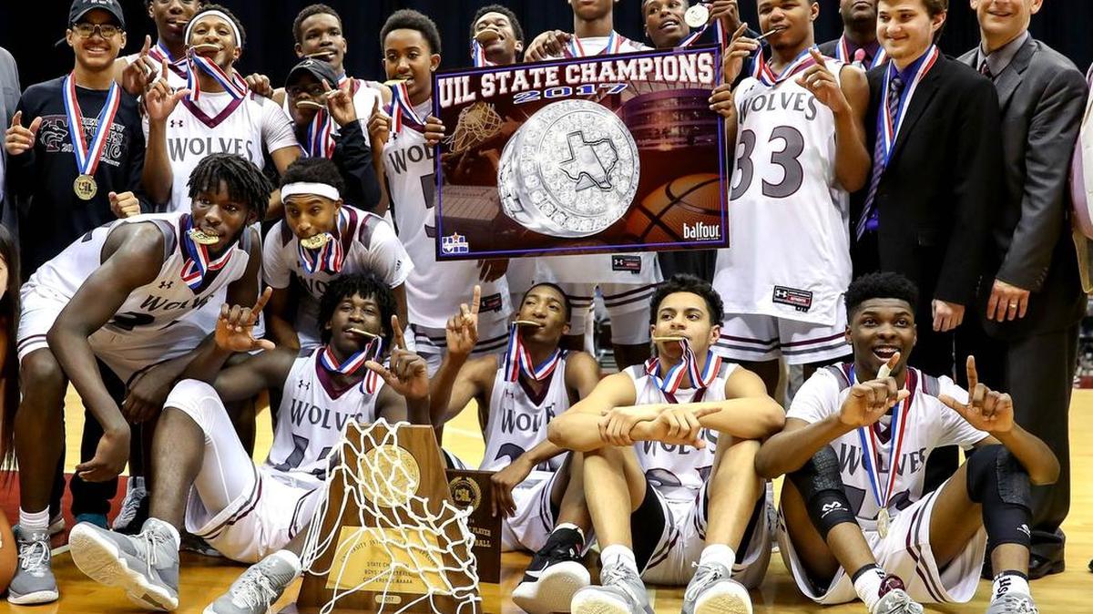 The Mansfield Timberview Wolves pose for photos after they beat Fort Bend Marshall 74-68 to win the UIL 5A Boys Basketball State Final, March 11, 2017 at the Alamodome in San Antonio.