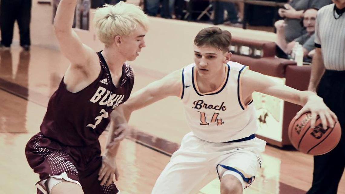 Brock’s Garrett Leek, right, looks for room around Bowie defender Keck Jones during a playoff game in Saginaw, Feb. 27, 2017.