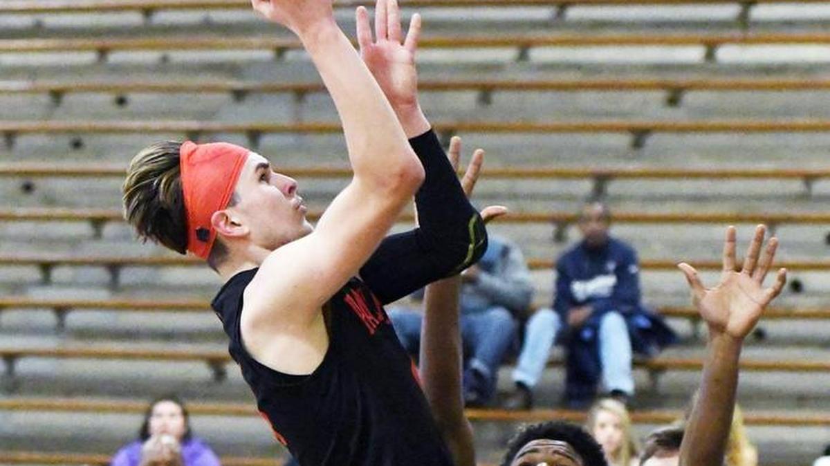 In a 2017 game, Colleyville Heritage guard Niko Bossinakis drives to the basket against a Fort Wirth Eastern Hills defender.