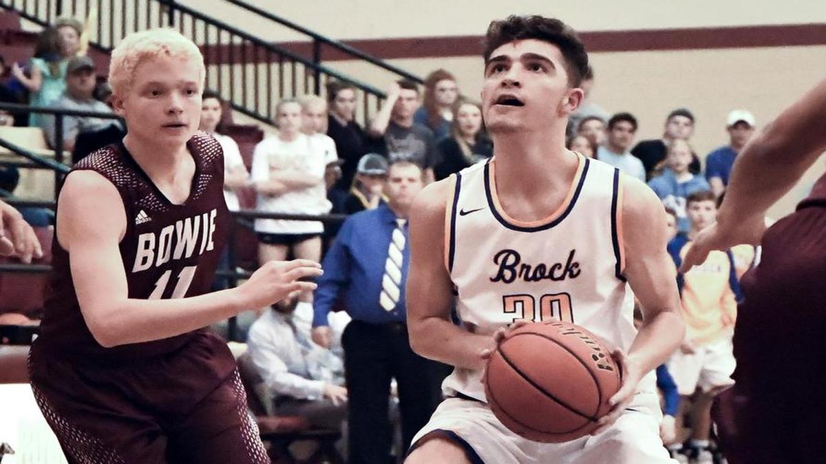 Taylor Perry, right, of Brock drives toward the basket past Bowie’s Spenser Meekins in Monday’s playoff game. Perry scored 25 points, including 12 in the fourth quarter, to fuel Brock’s victory.