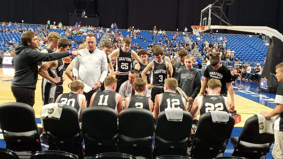 Graford head coach Jeff Bell, kneeling center, addresses his team during the break at the end of the first quarter of a Class 1A state semifinal game against Benjamin on Thursday, March 9, 2023 at the Alamodome in San Antonio, Texas.