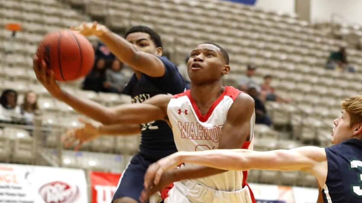 Arlington Martin point guard Jay’Len Wilson (30) splits Round Rock McNeil defenders in a recent non-district game.