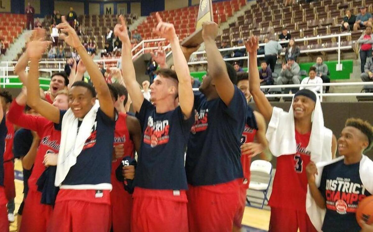 Justin Northwest players celebrate the Texans’ defeat of El Paso Burges, 65-62, in the 5A Region I final in Snyder.