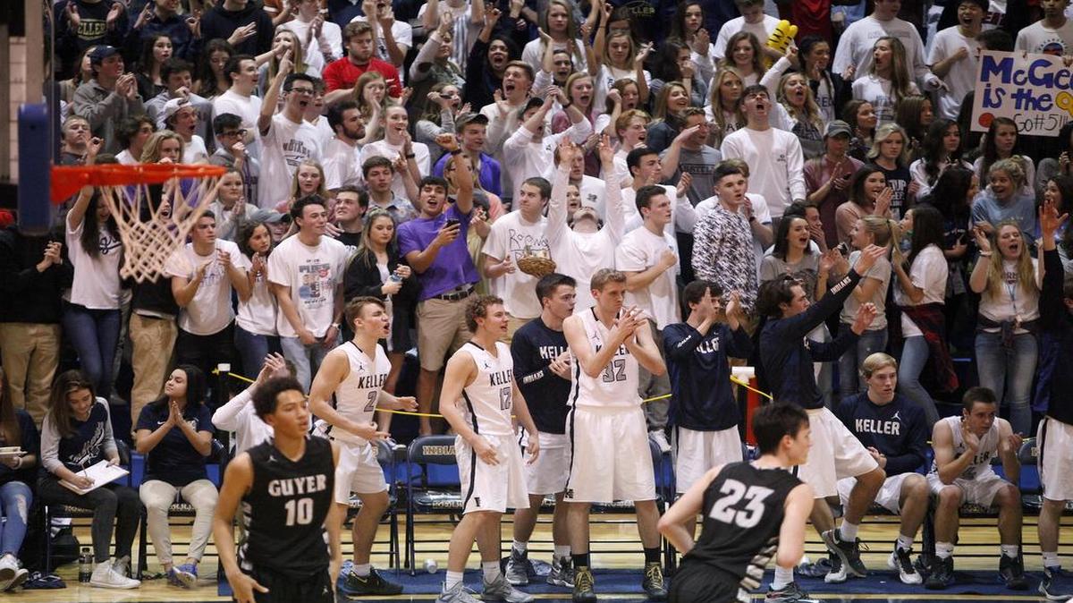 The Keller Indians bench and crowd cheers a three-pointer against the Denton Guyer Wildcats in the second half of high school boys basketball action at Keller High School in Keller, Texas on Friday, Feb. 12, 2016.