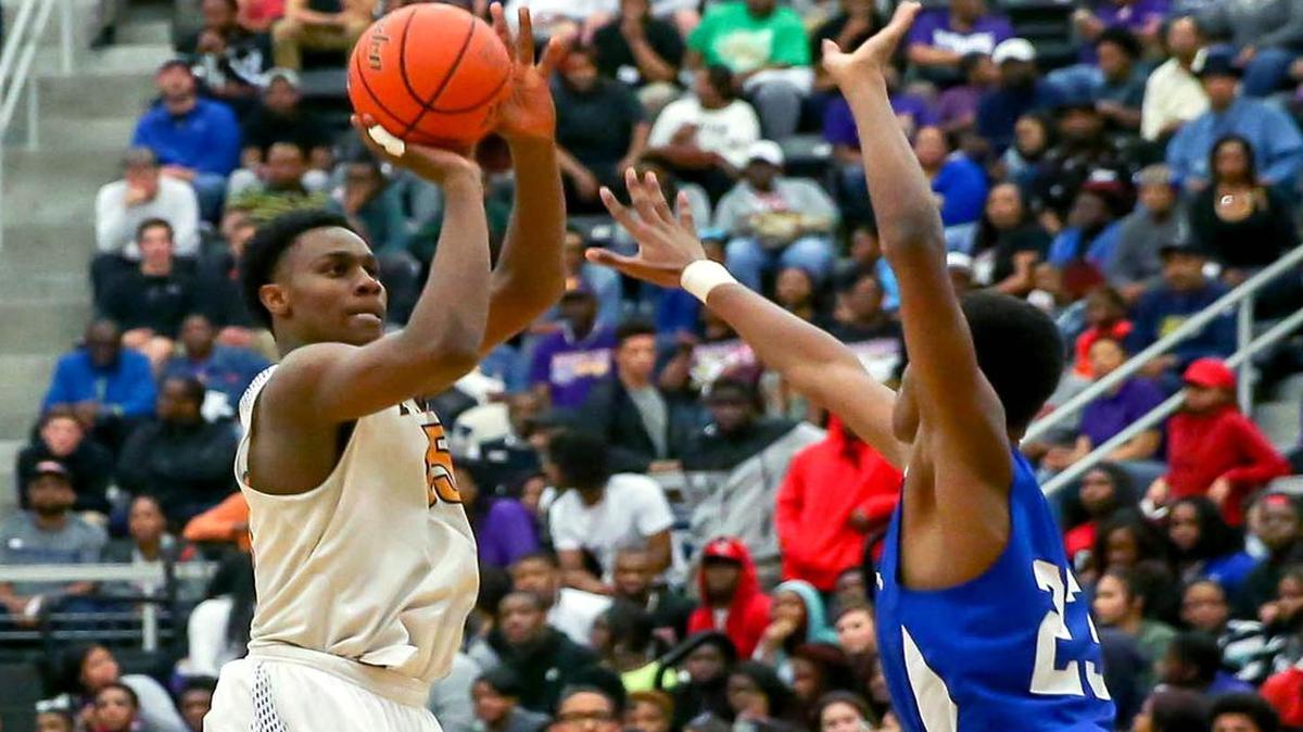 Everman forward Jonathan Jackson attempts a shot over Dunbar forward Jevon Maclin (23) during the third quarter, Tuesday night, March 1, 2016.