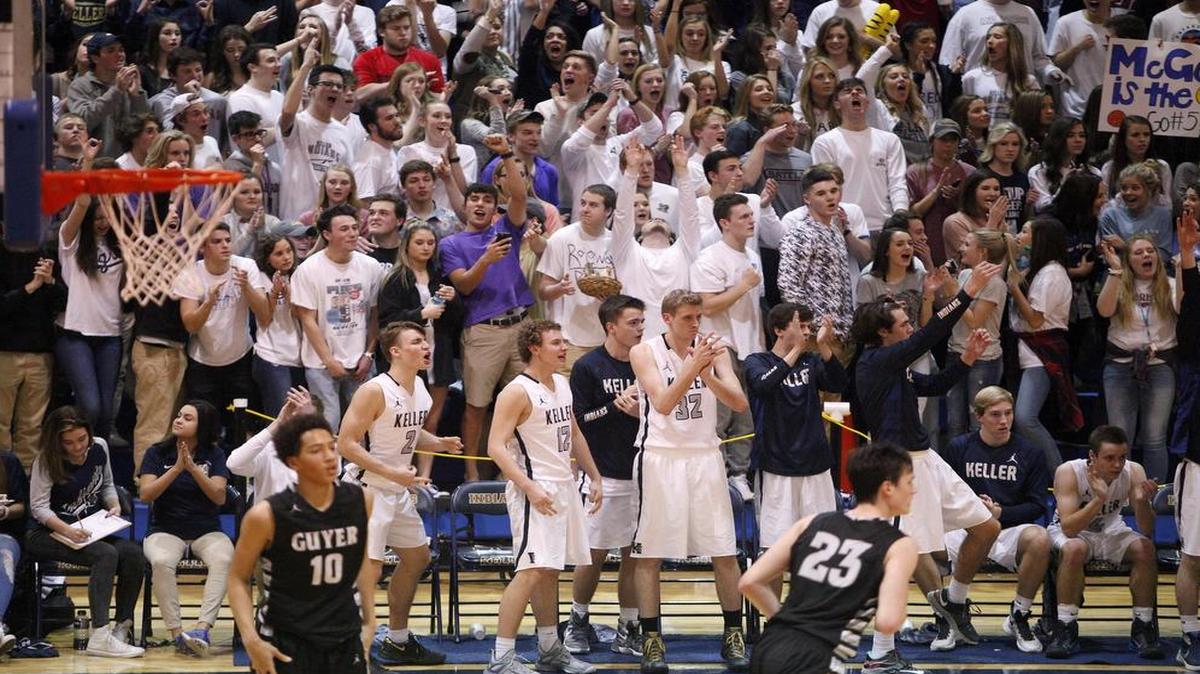 The Keller Indians bench and crowd cheers a three-pointer against the Denton Guyer Wildcats in the second half of high school boys basketball action at Keller High School on Friday, Feb. 12, 2016.