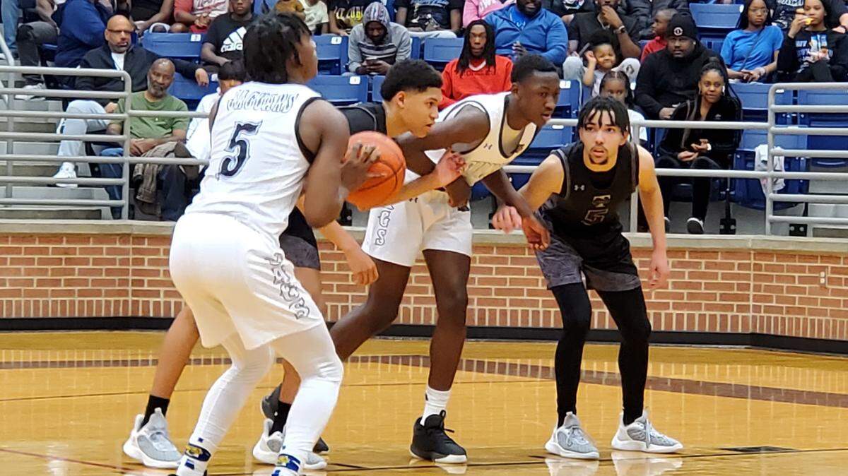 Mansfield Summit’s David Terrell (5), left, takes aim at a free throw as Timberview’s Lewis Sotelo (5), right, and Caleb Richard look to box out the Jaguars’ Ian Sedah in a Class 5A Region I quarterfinal on February 28, 2023 at Mansfield High School in Mansfield, Texas.