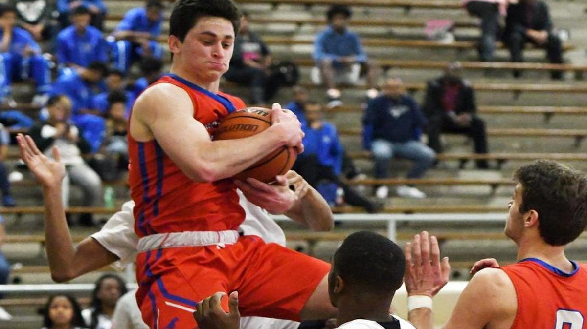 Grapevine’s Boone Montgomery, left, grabs the defensive rebound in front of Dunbar’s Kobe Hill and teammate Dalton Novotny, Jan. 16, 2017.