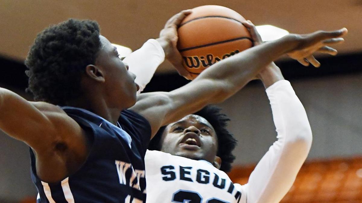 Fort Worth Wyatts’s Daylon Tanksley (12) defends Arlington Seguin’s Albert Davis (30) during the third period of Thursday’s Dec. 29, 2016, Fort Worth ISD Classic at Wilkerson-Greines Activity Center in Fort Worth. Wyatt went on to win 62-58.