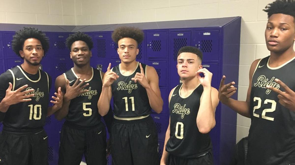 Keylan McNeil (11) with teammates in the Fossil Ridge locker room.