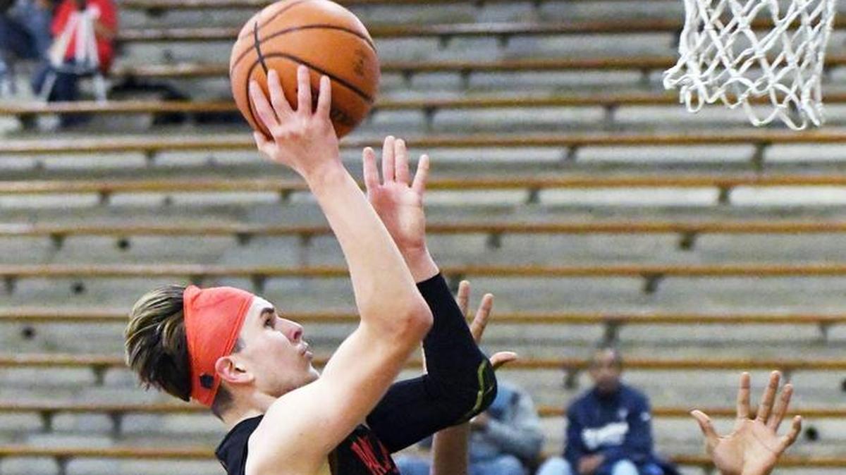 In a 2017 game, Colleyville Heritage guard Niko Bossinakis drives to the basket against a Fort Wirth Eastern Hills defender.