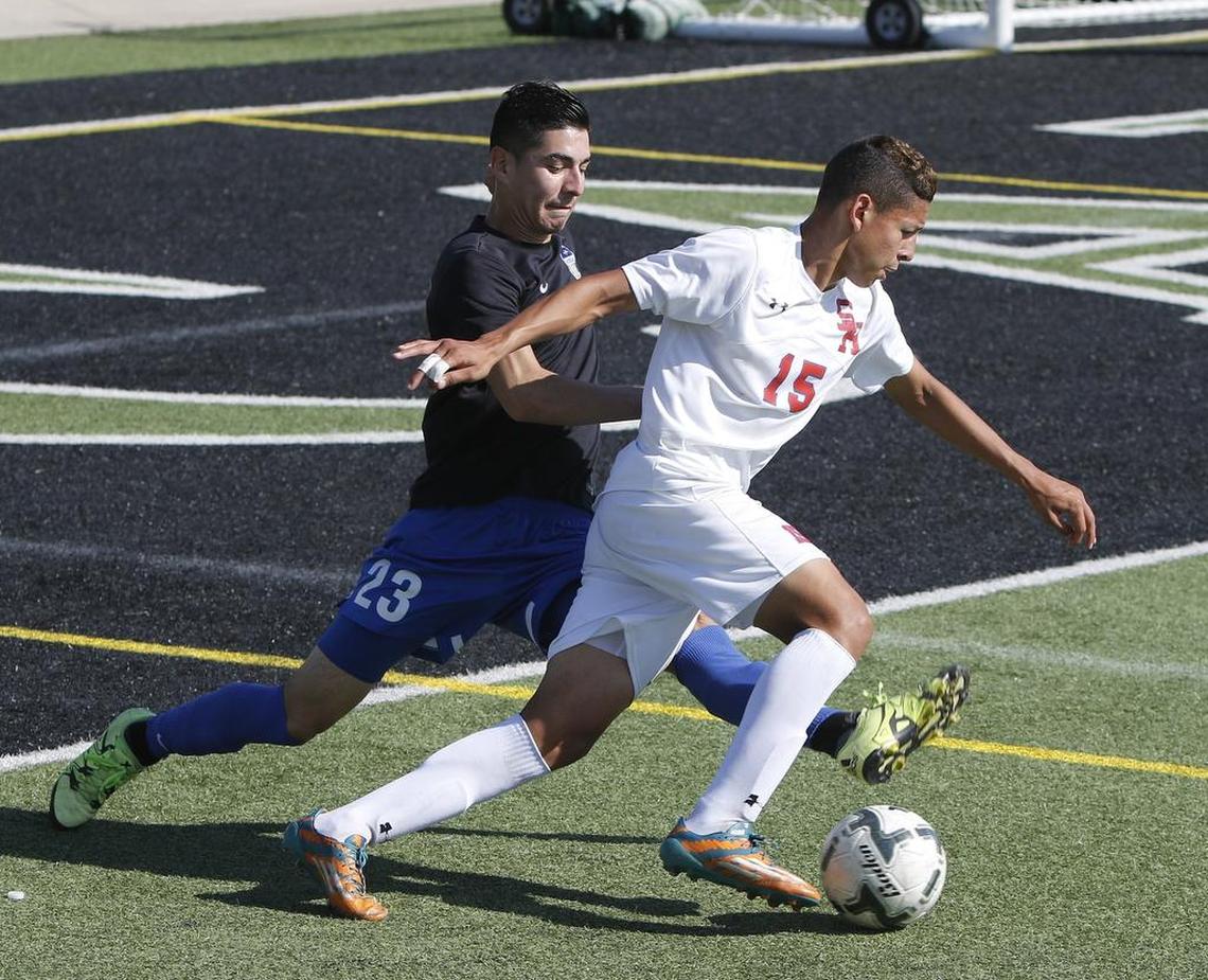 Sam Houston’s Jose Ortiz (15) crosses in front of Hebron’s Diego Hernandez (23) in the Class 6A Region I final, April 8, 2017.