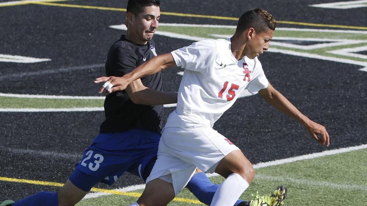 Sam Houston’s Jose Ortiz (15) crosses in front of Hebron’s Diego Hernandez (23) in the Class 6A Region I final, April 8, 2017.