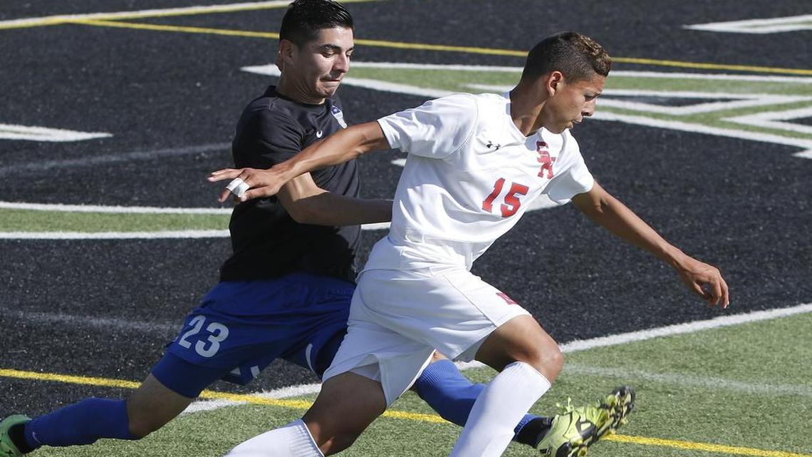 Sam Houston's Jose Ortiz (15) crosses in front of Hebron's Diego Hernandez (23) as Sam Houston played Hebron in a 6A Region 1 Finals Soccer game at Dragon Stadium Saturday April 08, 2017.