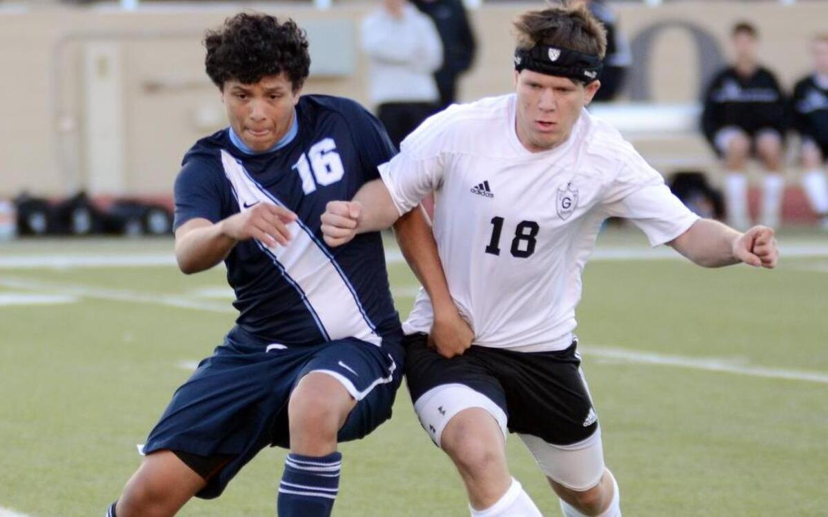 Wyatt's Juan Perez, left battles for the ball with Granbury's Bryce Gentry during the second half on Thursday March 26, 2015.