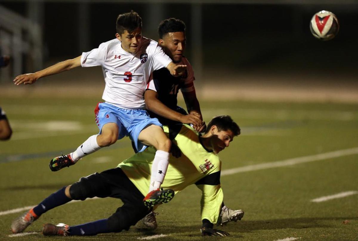 Castleberry’s Kevin Saldivar (3) collides with Waxahachie Life goalie Yari Rodriguez, March 23, 2017.