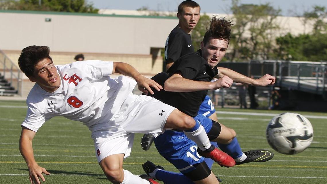 Sam Houston sophomore Nate Kopetsky (8) makes a shot on goal before Hebron’s Grant Paulette (12) runs into him Saturday. The Texans clinched a state berth with a 3-2 win over the Hawks in overtime.