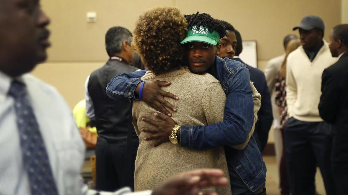 Arlington Martin football player and North Texas signee Tyler Wilson hugs his mother, Andrea Wilson, during National Signing Day at the Arlington ISD Professional Development Center in Arlington, Texas on Wednesday, Feb. 3, 2016.