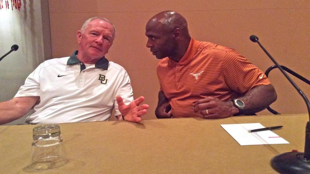 Baylor coach Jim Grobe, left, and Texas coach Charlie Strong converse at the annual coaches convention.