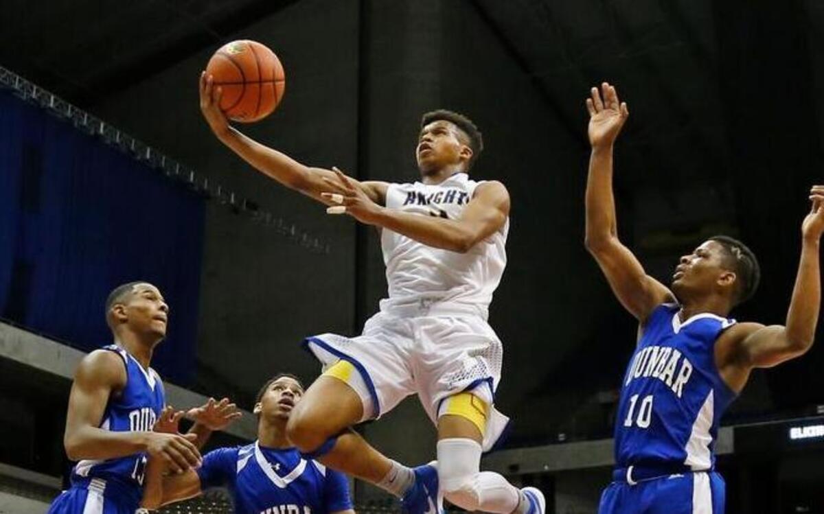 Fort Bend Elkins’ Chad Bowie sails through Dunbar defenders for a basket during Thursday’s Class 5A semifinal game at the Alamodome.
