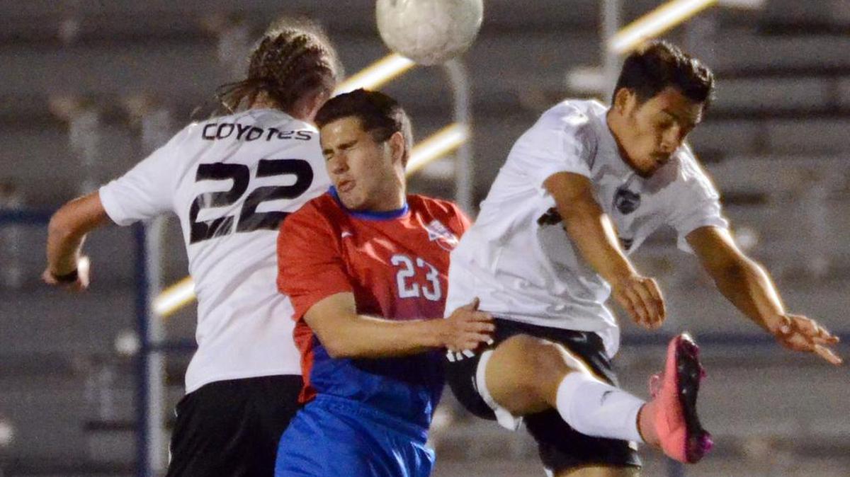 Grapevine’s John Morin, center heads the ball between Wichita Falls’s Josh Memath, left and Richy Acosta in the second half during Tuesday’s April 5, 2016 playoff soccer game at Brewer High School in White Settlement. Grapevine went on to win 1-0.