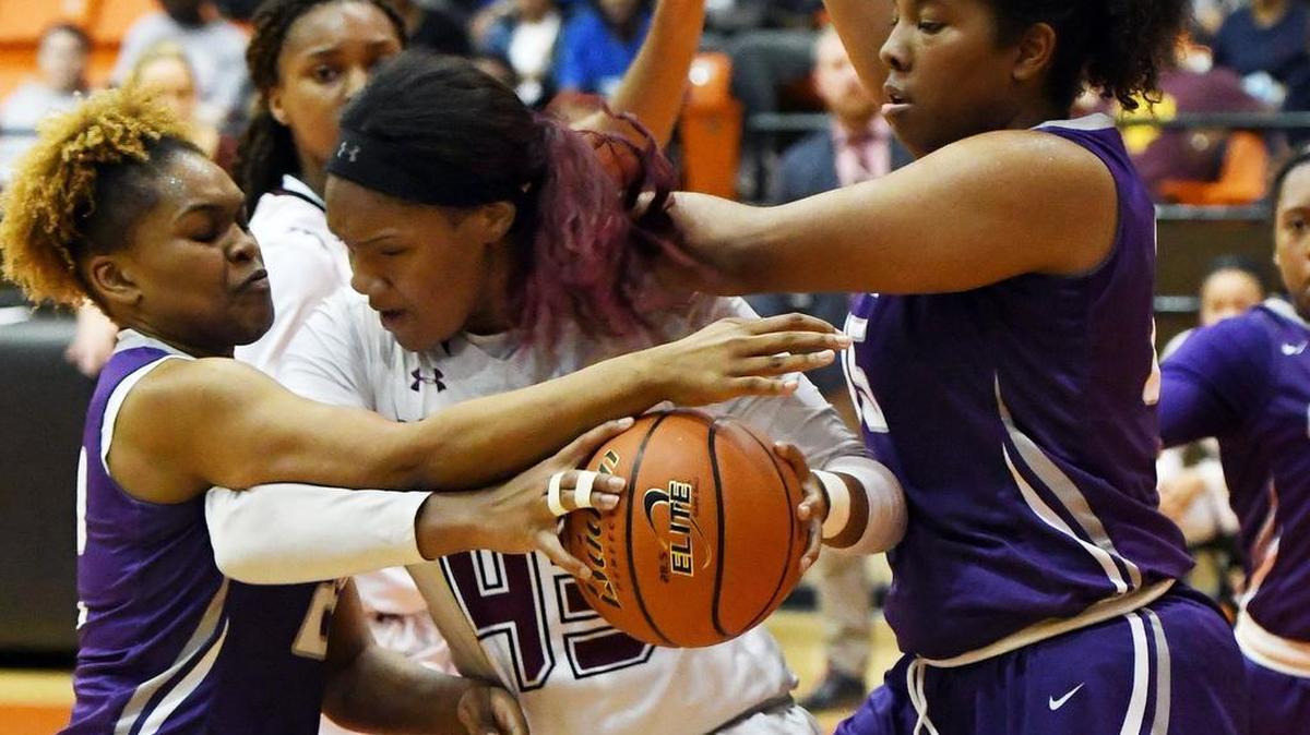 In 2017 playoff action, Timberbview forward Lauryn Thompson, center, fights to keep the ball from Crowley defenders Tiara Weisner, left, and Makayla Johnson.