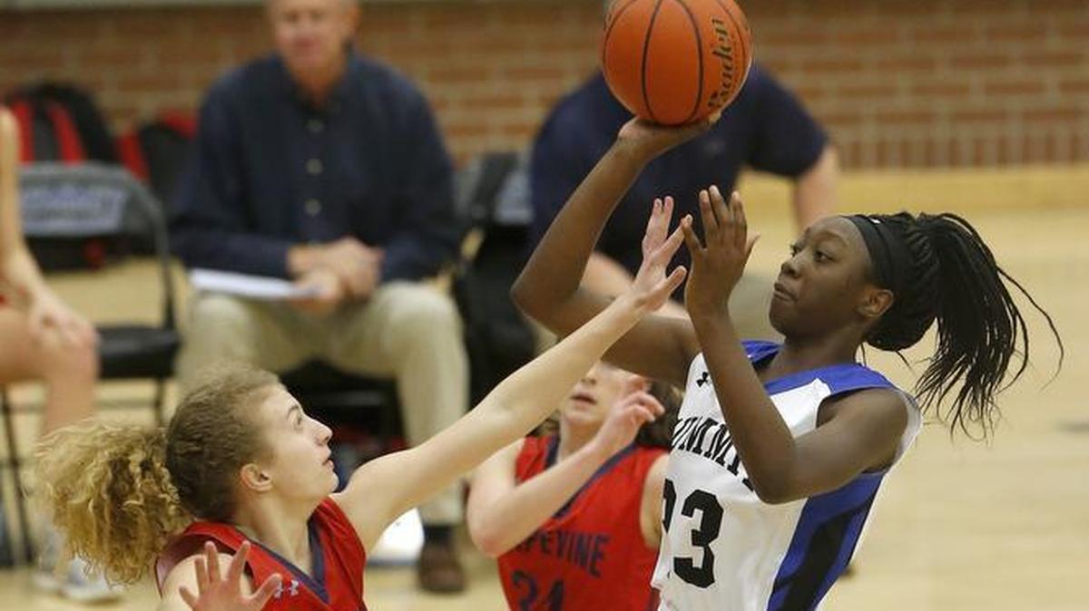 Mansfield Summit post Tommisha Lampkin shoots over Grapevine’s Kate Dickson in the first half in the Mansfield Spring Creek high school basketball tournament in 2017.