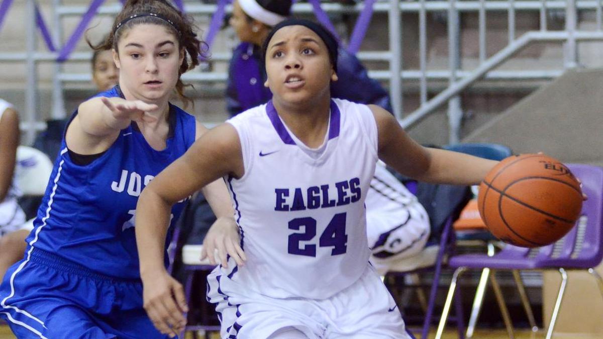 Crowley's Taelour Pruitt, right, drives to the basket against Joshua's Kailey Curlee in the fourth period during Friday's January 30, 2015 basketball game at Crowley High School.