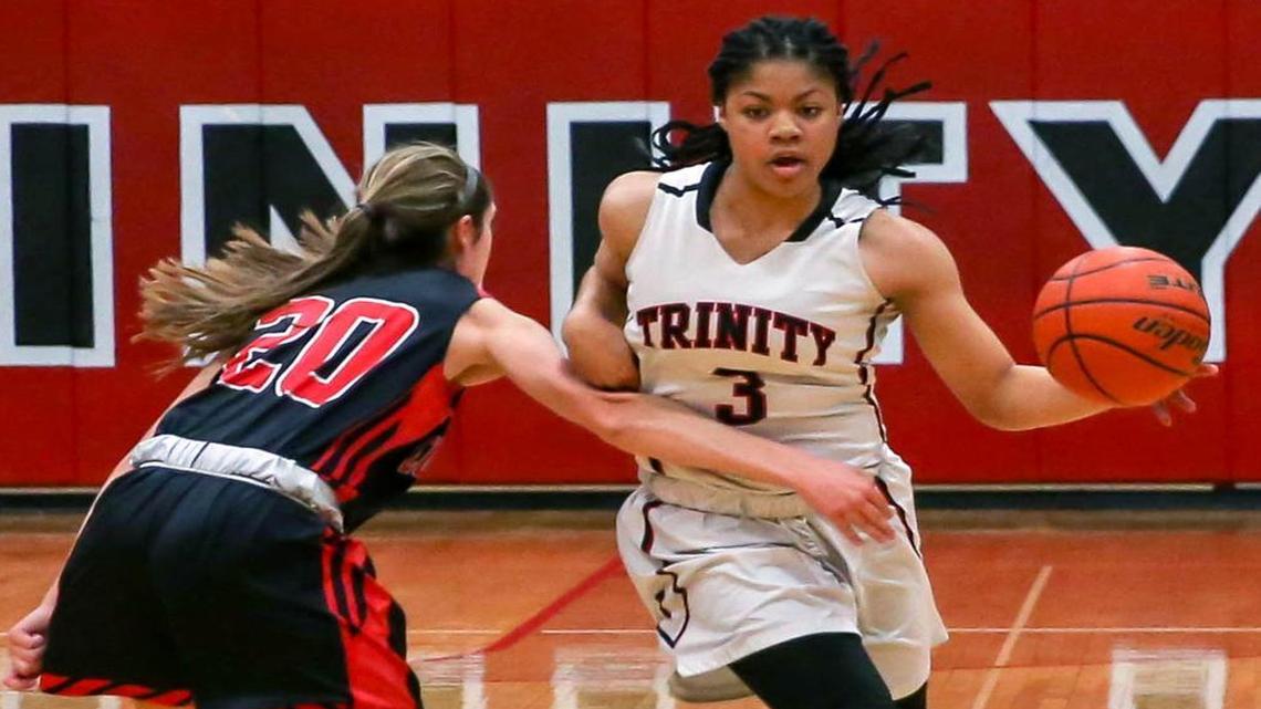 Trinity guard Trinity Oliver (3) tries to get past Colleyville Heritage guard Caitlyn Foster (20) during the first half Tuesday evening, January 26, 2016.