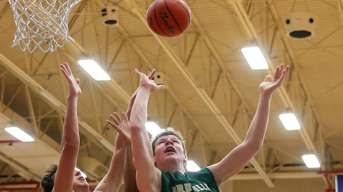 Birdville forward Will Sorrells (30) draws Grapevine defenders Matthew Green (5) and Andrew Lastinger (42), Jan. 8, 2016.
