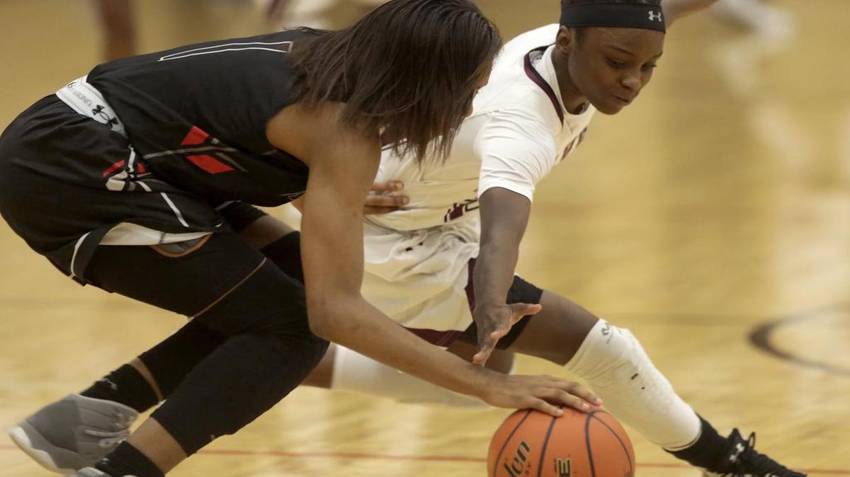 Mansfield Timberview guard Trelynn Tyler, right, goes for a steal against Cedar Hill guard Dajinae McCarty, Dec. 29, 2016.