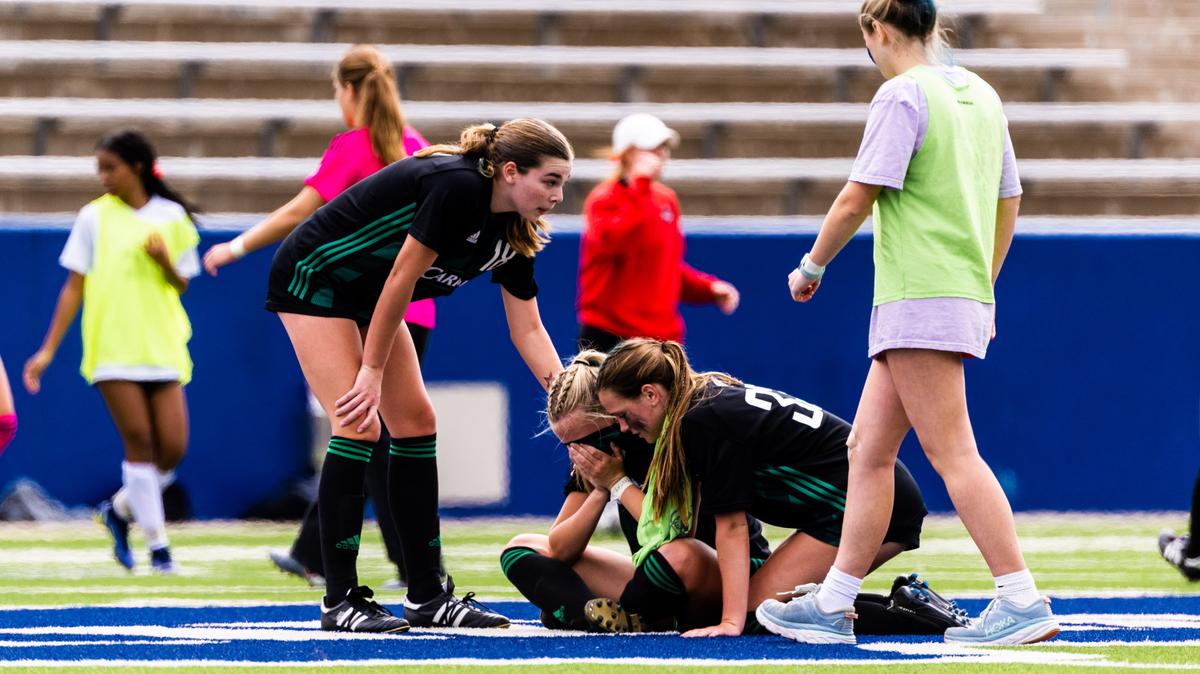 Southlake Carroll’s Parker Wilkerson (18), standing left, and Laney Maclin (33), kneeling right, console teammate Marley Naughton (22), seated center, after the Dragons lost to Flower Mound Marcus 1-0 on an own goal in the Class 6A Region I final on Saturday, April 8, 2023 at McKinney ISD Stadium in McKinney, Texas.