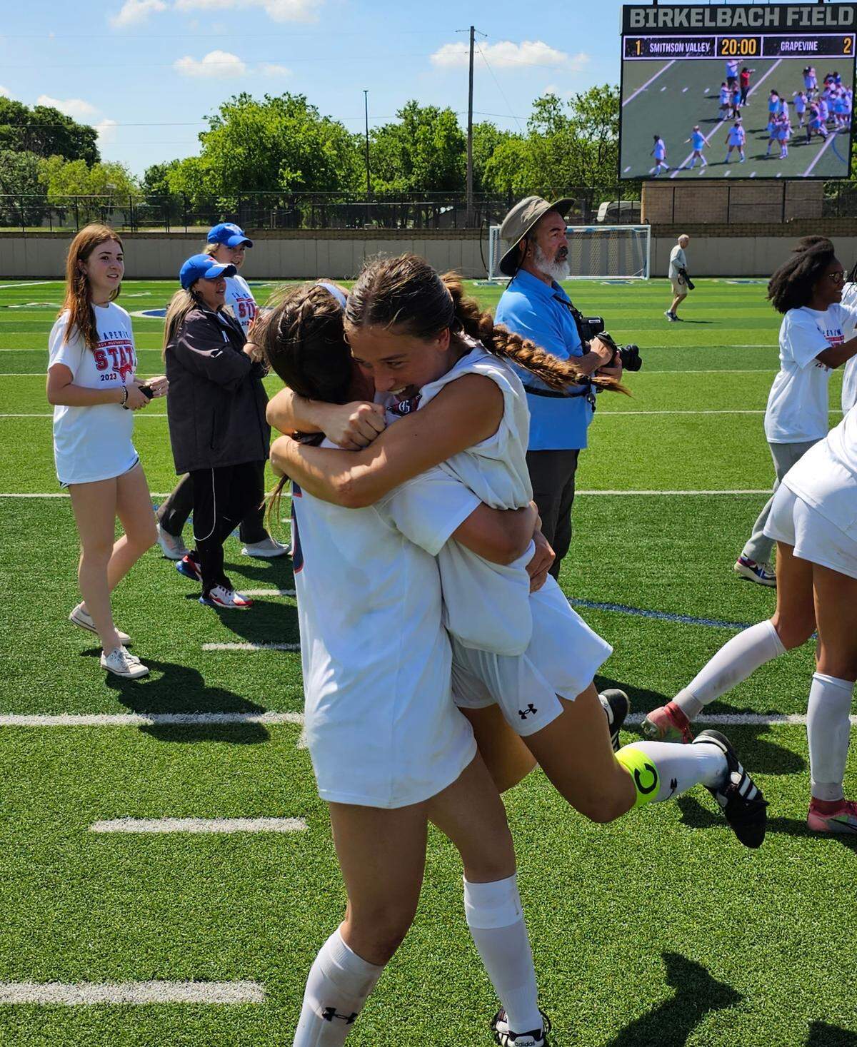 Grapevine’s Samantha Lumpkin, left, lifts Theresa McCullough off the ground in an embrace after their Class 5A state semifinal on Thursday, April 13, 2023 at Birkelbach Field in Georgetown, Texas. McCullough scored two goals in the Mustang’s win.
