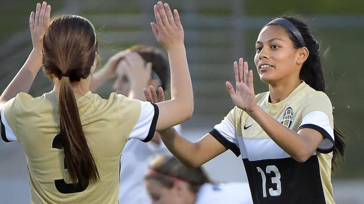 Mansfield’s Peyton Jameson (3) celebrates with Julie Shahi (13) after Shahi’s second-half goal against Colleyville Heritage, March 25, 2016.
