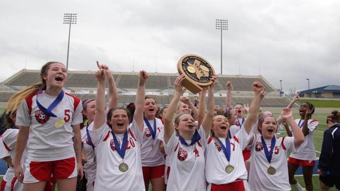 Grapevine Faith players celebrate their TAPPS Division II soccer state championship.