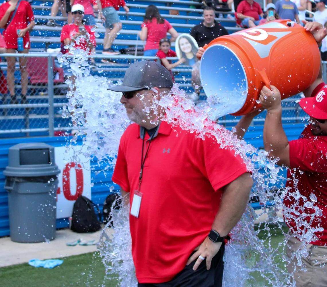 Grapevine coach Steve McBride gets an ice water bath after his Mustangs defeated Frisco in the girls Class 5A state championship game on Saturday, April 15, 2023 at Birkelbach Field in Georgetown, Texas.