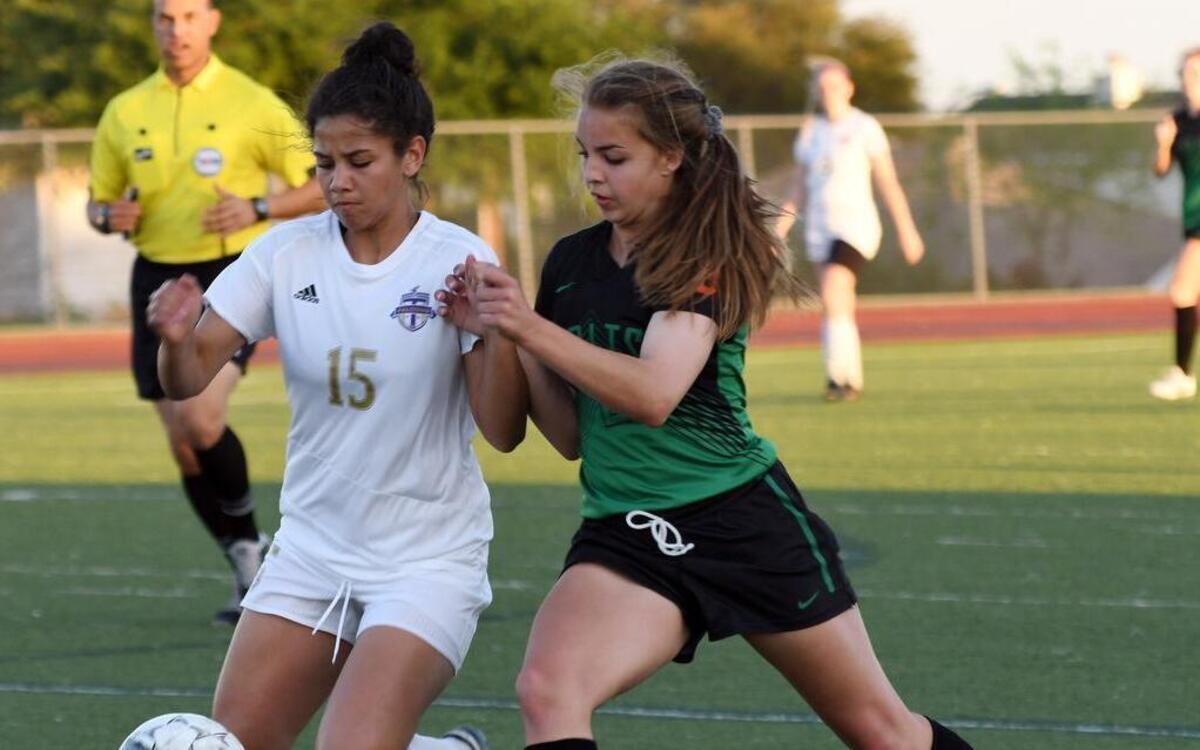 Timber Creek’s Megan Rayford (15) and Arlington’s Caroline Pool battle for the ball in the first half of Thursday’s soccer game at Fossil Ridge High School, March 23, 2017.
