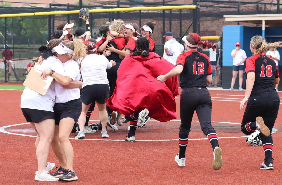 The Colleyville Heritage softball team mobs pitcher Lindsey McConnell after shutting out Justin Northwest in Game 3 of their Class 5A Region I Final series on Saturday, May 27, 2023 at Byron Nelson High School in Trophy Club, Texas.
