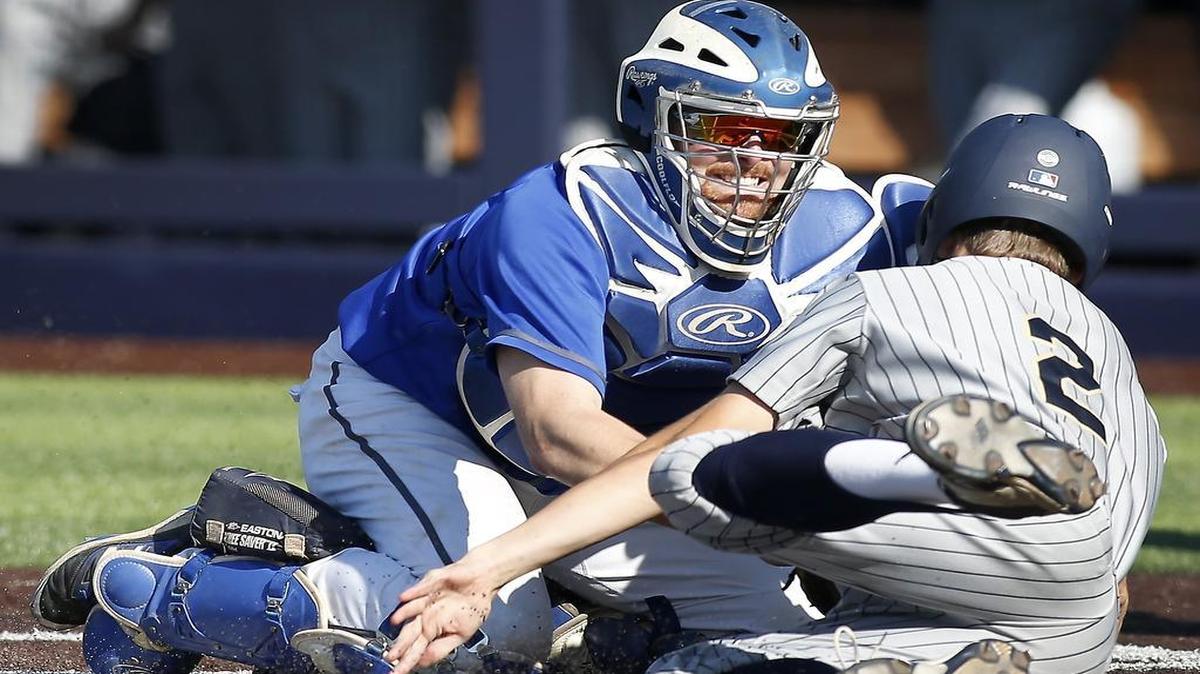 Hebron catcher Michael Neustifter (16) makes the tag on Keller’s Parks Bouck (2) in the fourth inning on Friday at Dallas Baptist University Keller won 4-1 to win the best of three series 2-0.