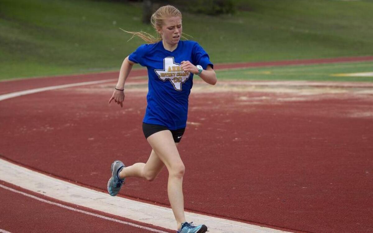 Maddie Vondra takes a lap with the team during practice with the UIL state-qualifying boys cross country track team at Arlington Heights High School on Wednesday, November 4, 2015.