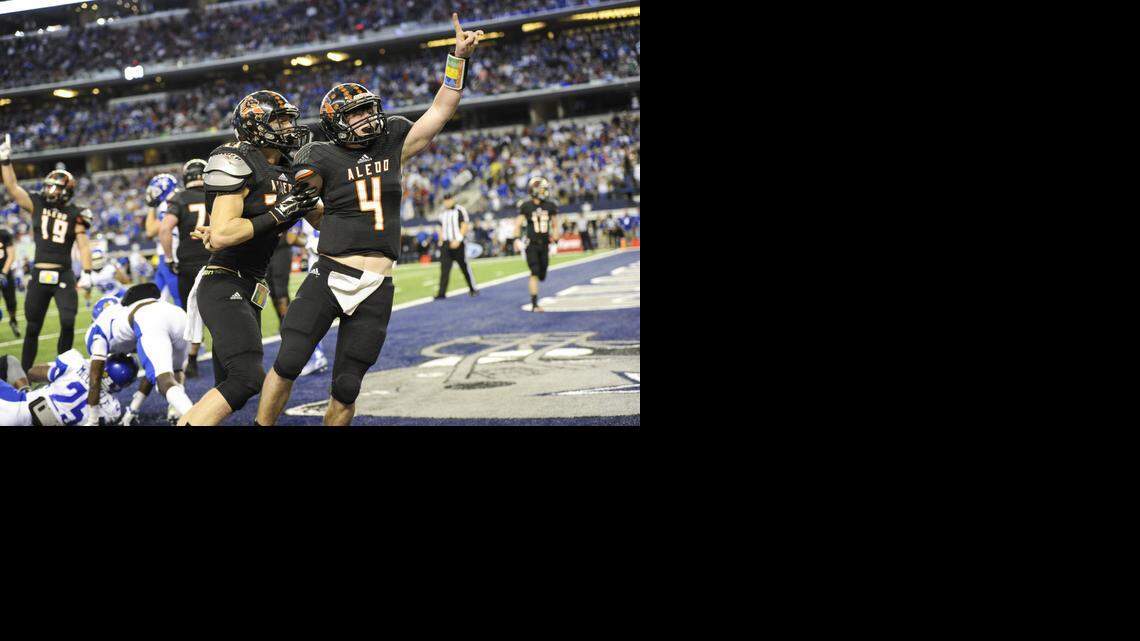 
Aledo quarterback Luke Bishop celebrates after scoring the winning touchdown. with under a minute remaining in the game to put Aledo on top of Temple High School 49-45 during the 5A Division I high school football championship game at AT&T Stadium in Arlington, Texas, Saturday, December 20, 2014. (Special to the Star-Telegram/Michael Prengler)
