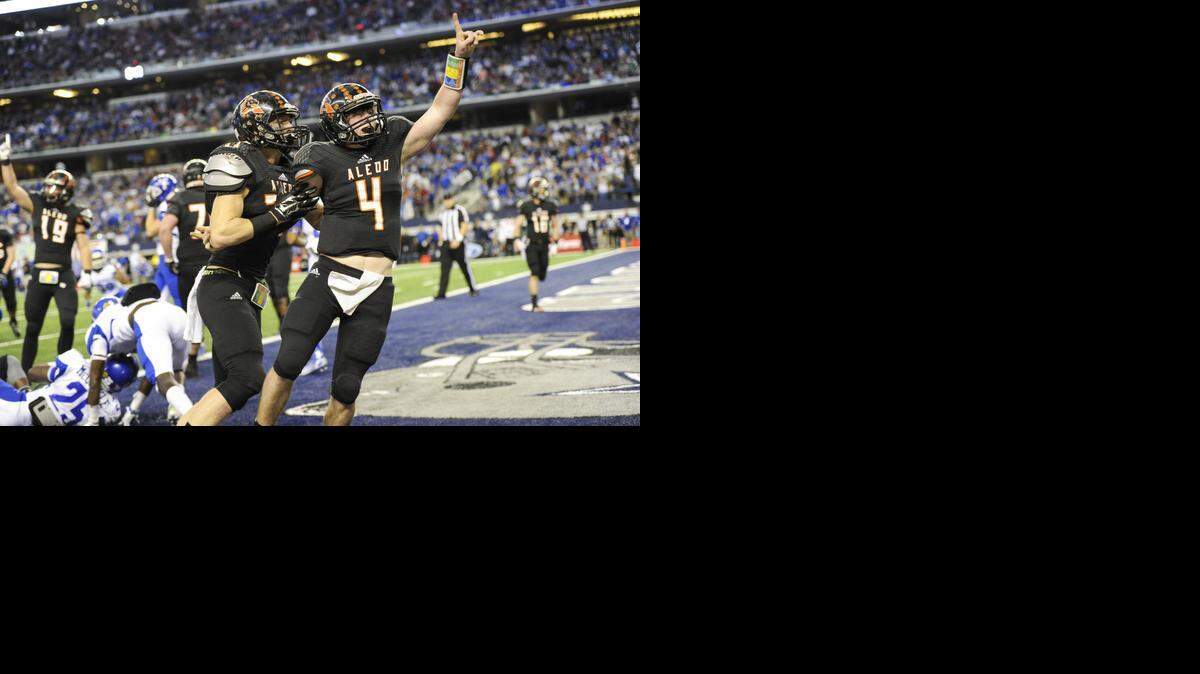 
Aledo quarterback Luke Bishop celebrates after scoring the winning touchdown. with under a minute remaining in the game to put Aledo on top of Temple High School 49-45 during the 5A Division I high school football championship game at AT&T Stadium in Arlington, Texas, Saturday, December 20, 2014. (Special to the Star-Telegram/Michael Prengler)
