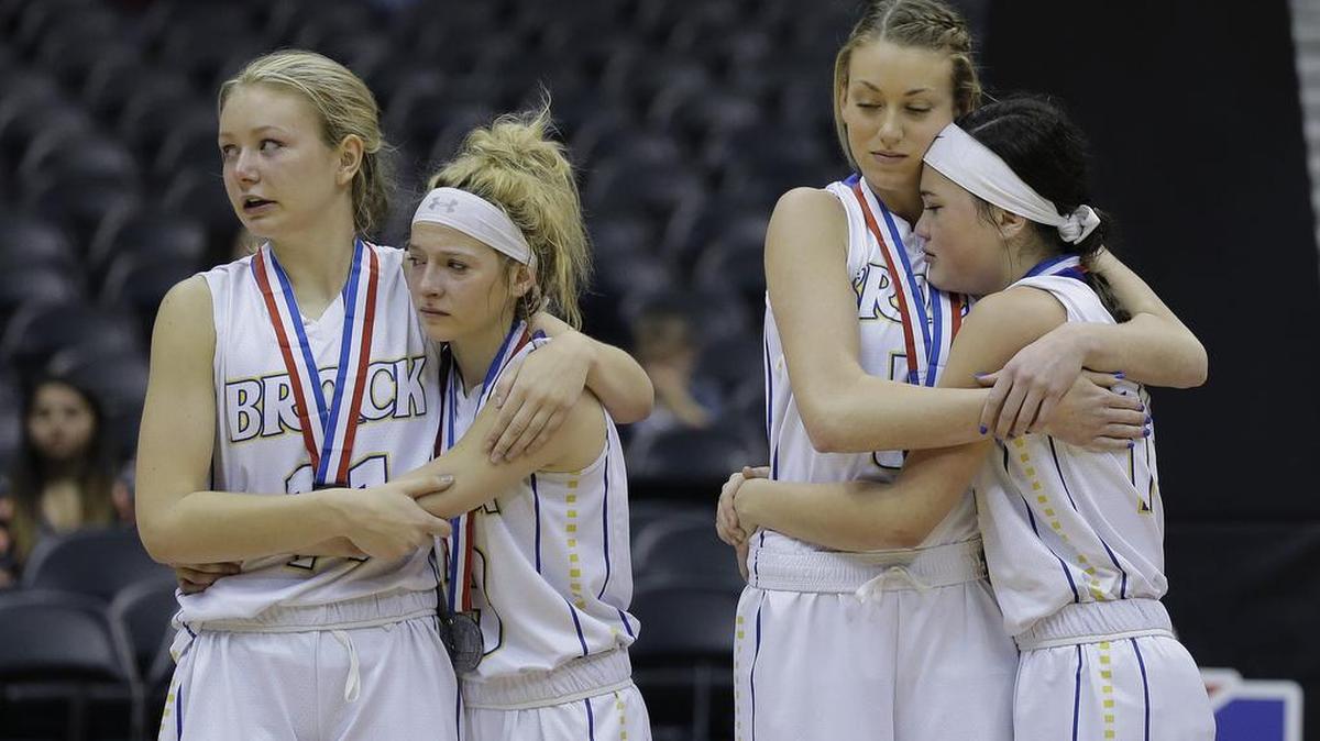Brock players, from left, Emilee Popeck, Trisha Jacobs, Emily Wahlenmaier and Rylee Lavender stand together as they receive their silver medals after losing to Wall in a UIL Class 3A girls high school state final basketball game Saturday in San Antonio. Wall won 24-21.