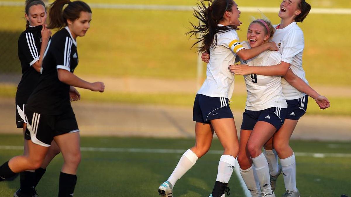 Arlington Heights players Hannah Dixon, Melissa Woodson (9) and Myca Crum celebrate a goal against Burleson in the second half.