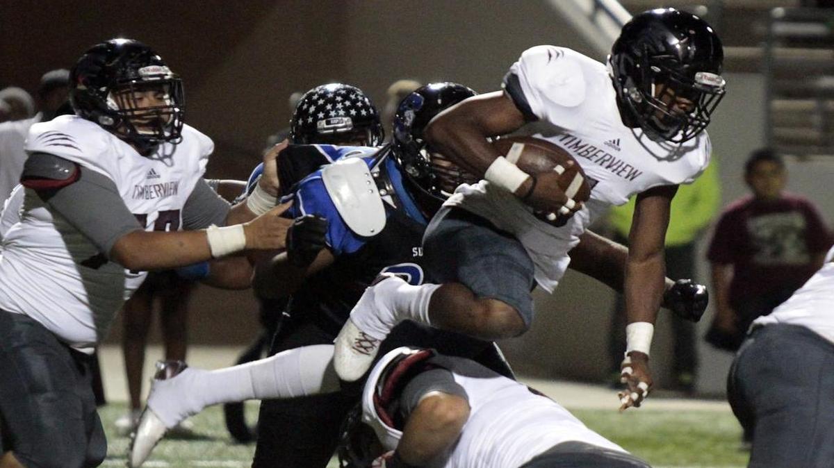 Mansfield Timberview junior RB Audricke Gaines (5) leaps over a block as Mansfield Timberview and Mansfield Summit High School varsity football teams met at Vernon Newsom Stadium in Mansfield, Texas, on Friday, 06 November, 2015.